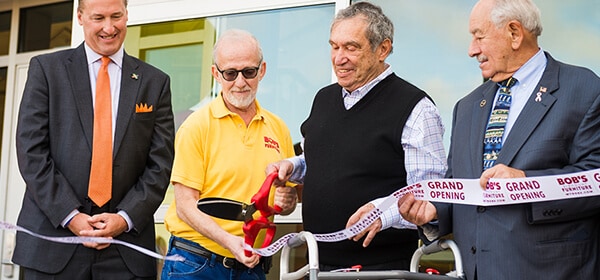 Bob Kaufman, co-founder of Bob's Discount Furniture, cuts the ribbon for the new Manchester, Connecticut headquarters