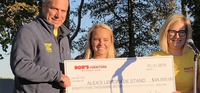 A check is presented to Alex's Lemonade Stand Foundation by a Bob's employee